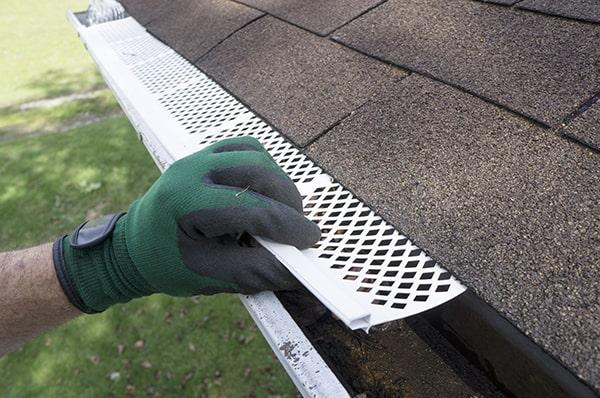 gutter guards can help prevent ice dams by keeping gutters clear of debris, allowing for proper water flow and drainage